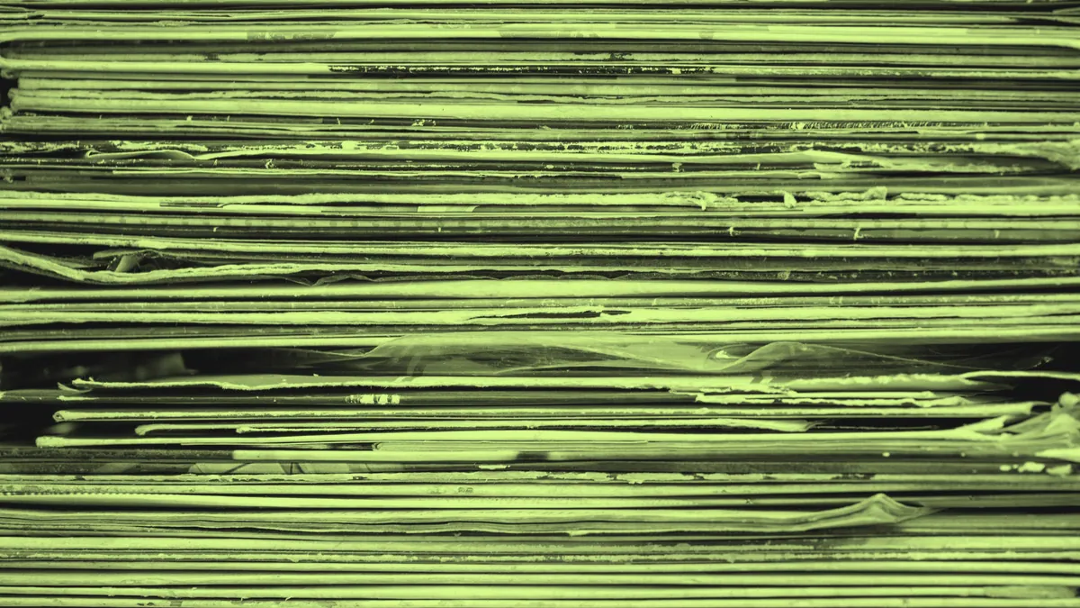 A stack of vinyl records spanning genres.