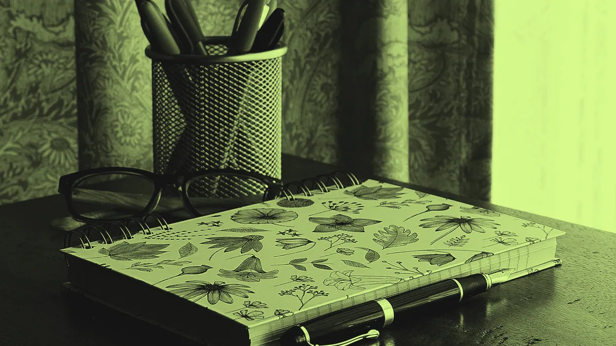 A notebook and pen for writing lyrics.