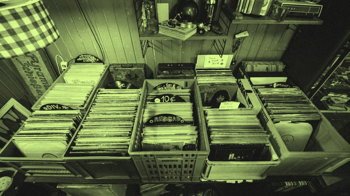 Crates of vinyl records sorted by genre.